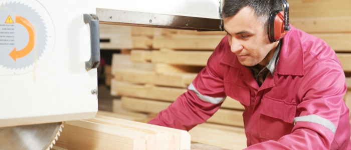 Employee working with wooden panels in warehouse